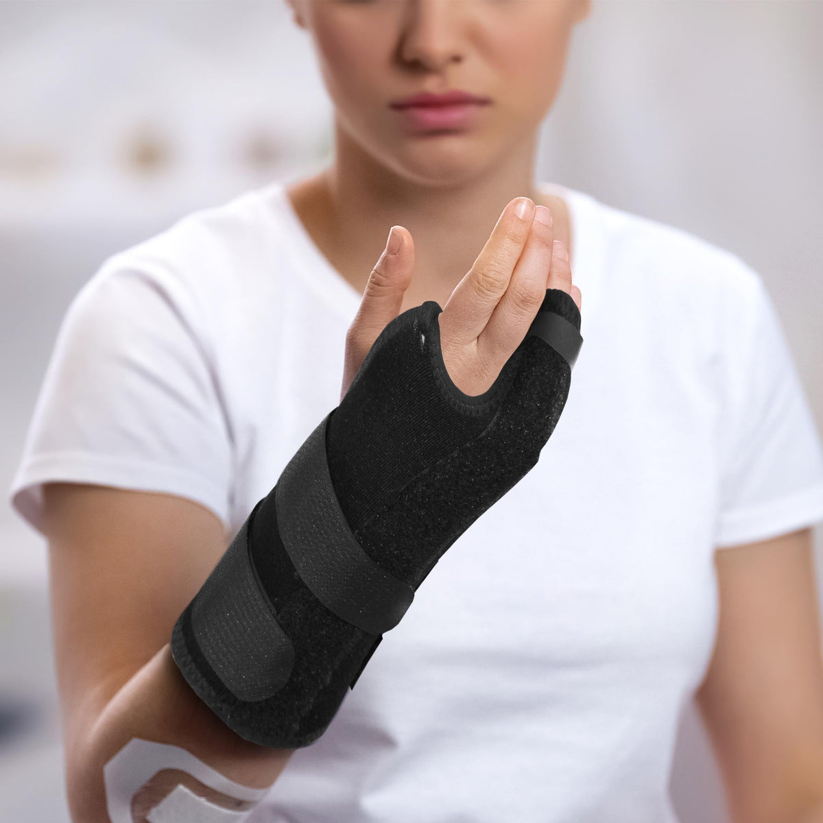 Woman wearing Boxer Orthosis hand and wrist brace for metacarpal fracture recovery - 283265, 283262, 283266, 283263, 283267, 282550, 283268, 283264